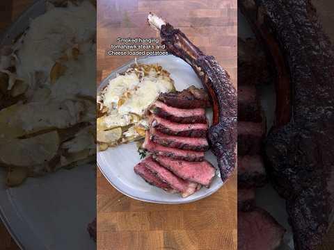 Smoked hanging tomahawks steaks with cheese loaded potatoes